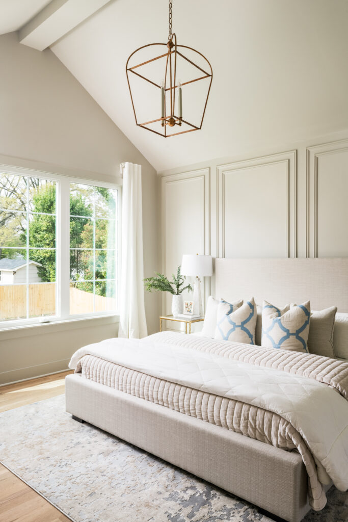 Move-in-ready luxury primary bedroom with vaulted ceiling, large windows, and designer finishes