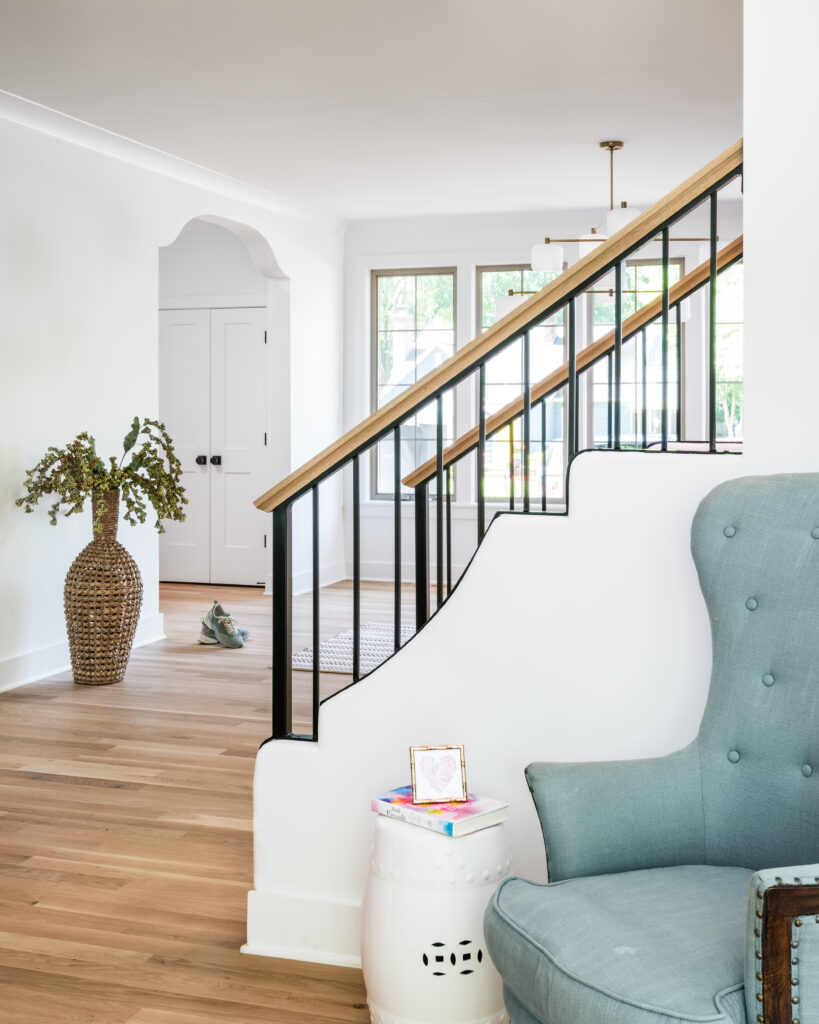 Grand entryway with custom staircase, hardwood floors, and open-concept design in a luxury new construction home