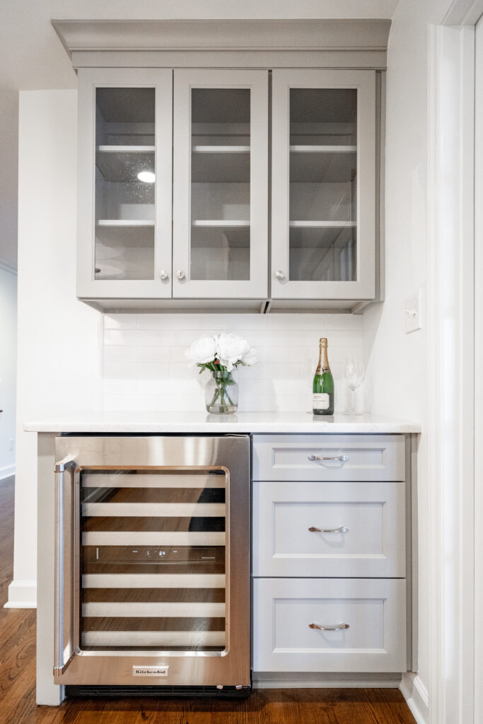 Dry bar with custom cabinetry and beverage fridge in luxury home by Springdale Custom Builders